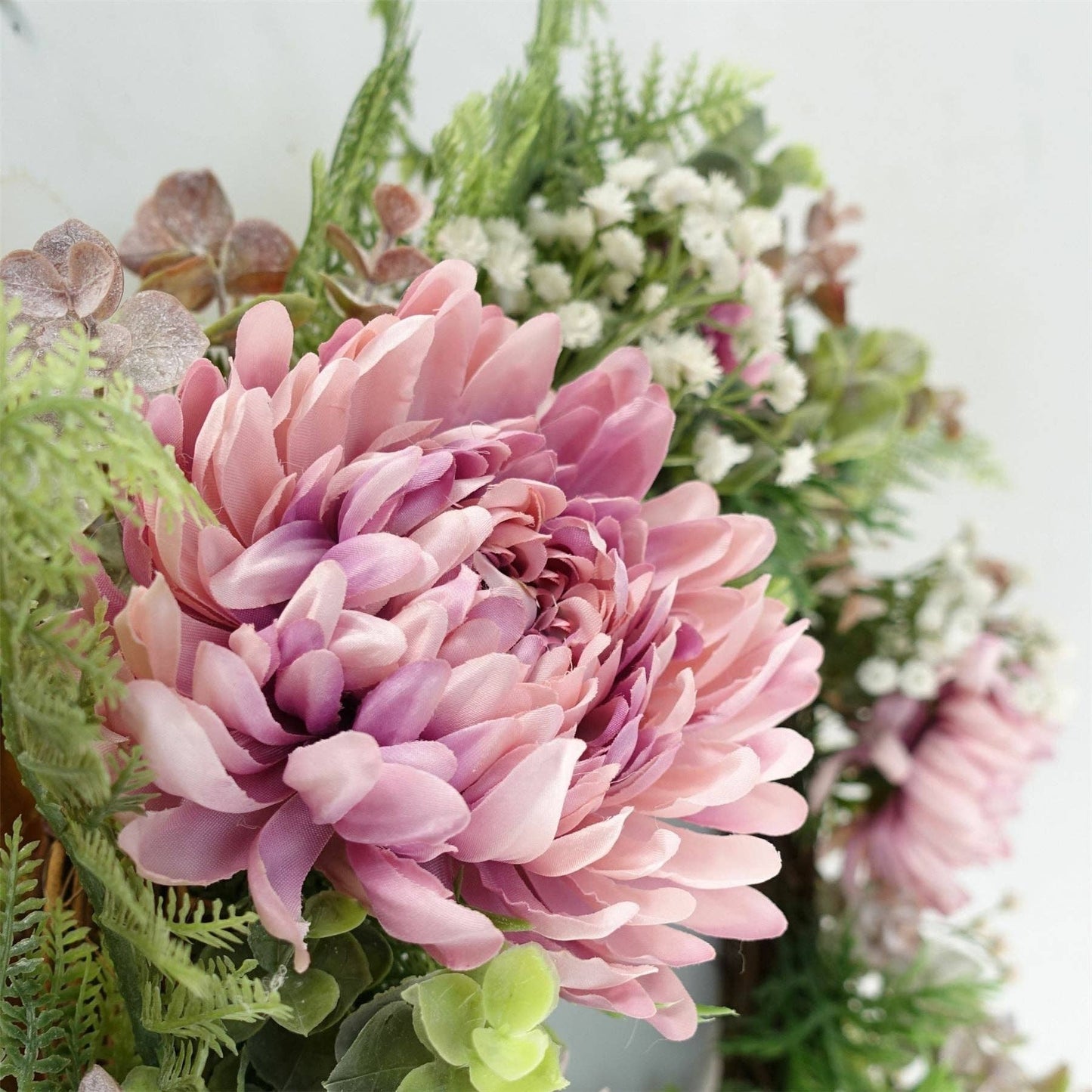 Close-up of a pink flower with green foliage in the background