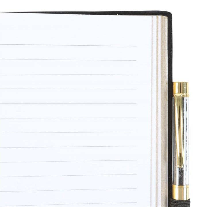 Notebook with gold pen on a white background