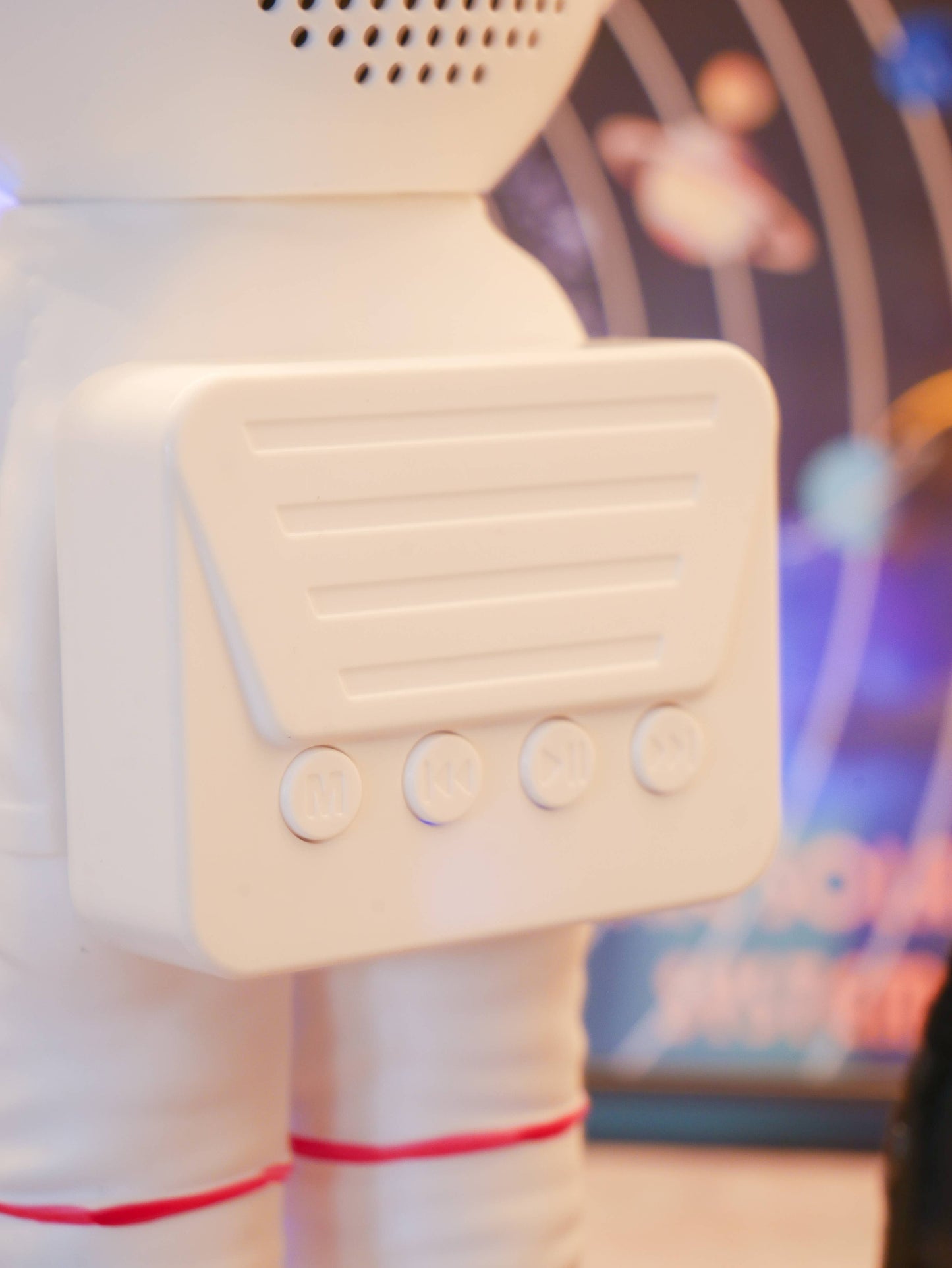 White robot-like figure with a blurred colorful background