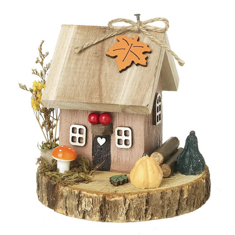 Wooden decorative house with a leaf on top, surrounded by autumn-themed items on a white background.