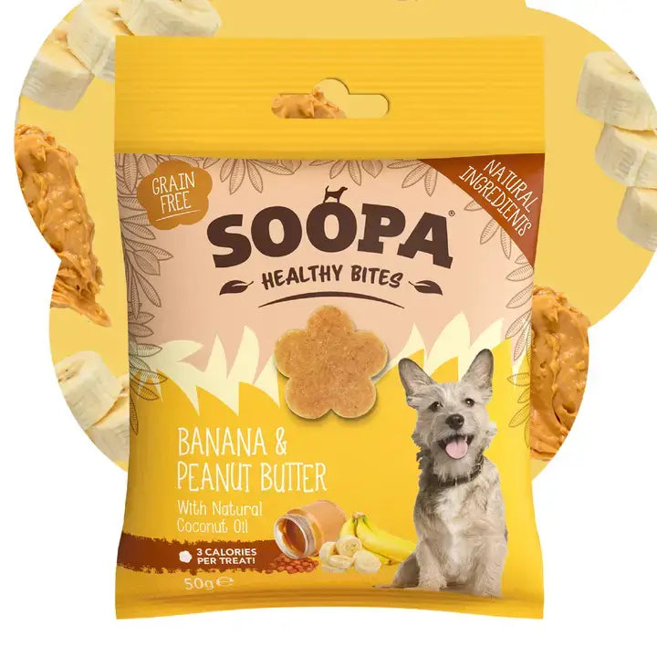 A bag of Soopa Healthy Bites dog treats in Banana & Peanut Butter flavor, shown against a yellow background with banana slices and peanut butter pieces around it. The package is yellow and beige with a photo of a dog on the front.