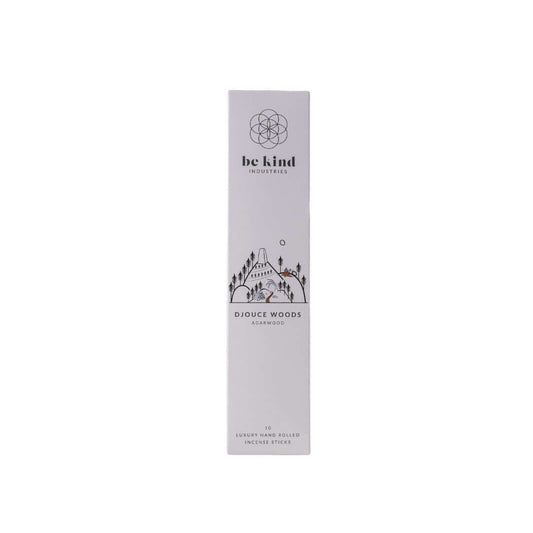 A package of Be Kind brand incense sticks labeled 'Djouce Woods' with a graphic design featuring trees and a cabin in the woods.