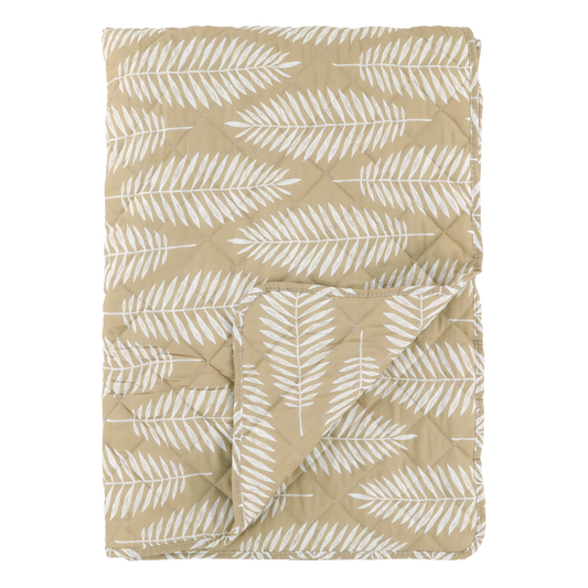 Beige quilt with white leaf pattern on a white background