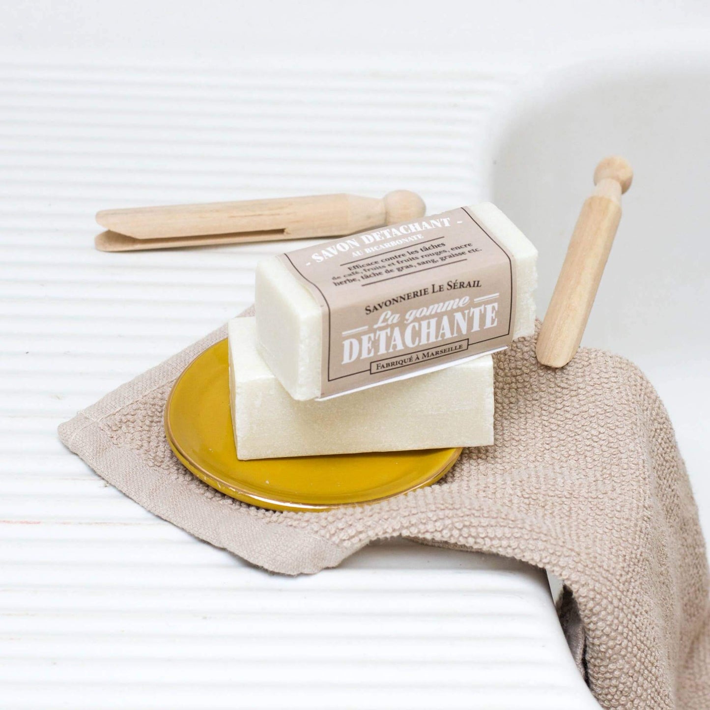 Bicarbonate stain remover soap on a soap dish with pegs