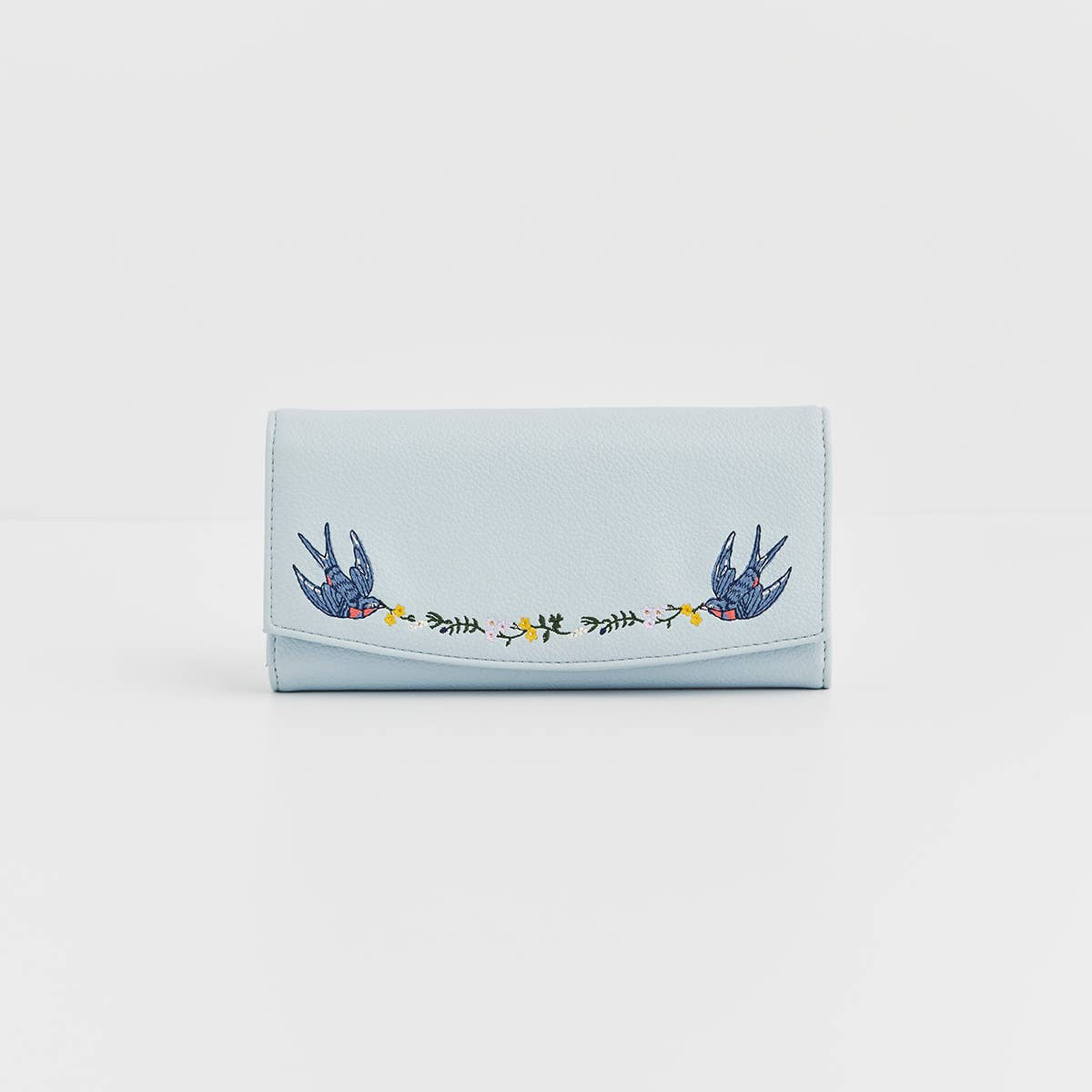 Light blue wallet with embroidered designs on a white background