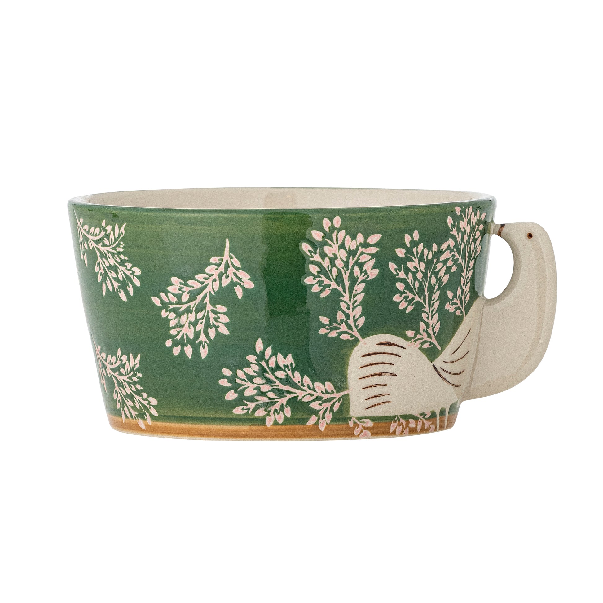 Green ceramic mug with white floral patterns on a white background