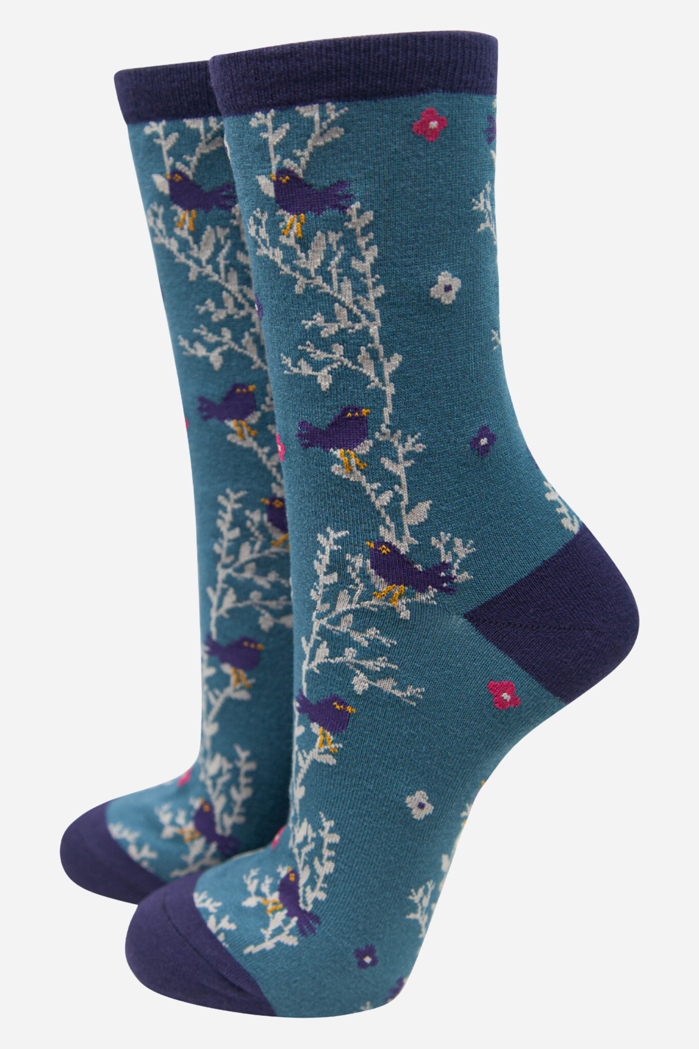 Pair of blue socks with floral and bird pattern on a white background