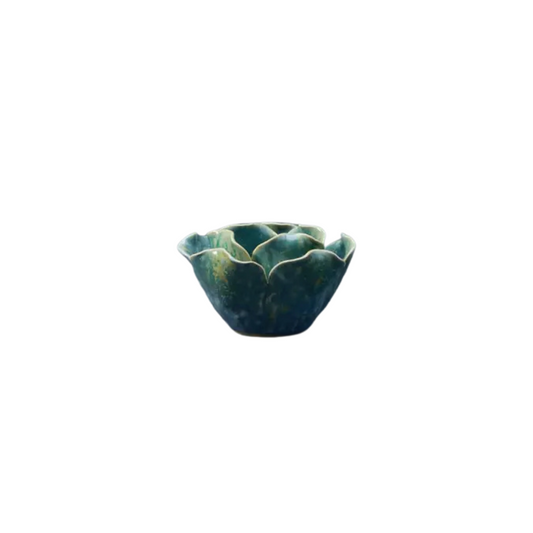 Graduated Blue coloured ceramic t light holder in the shape of a flower on a white background