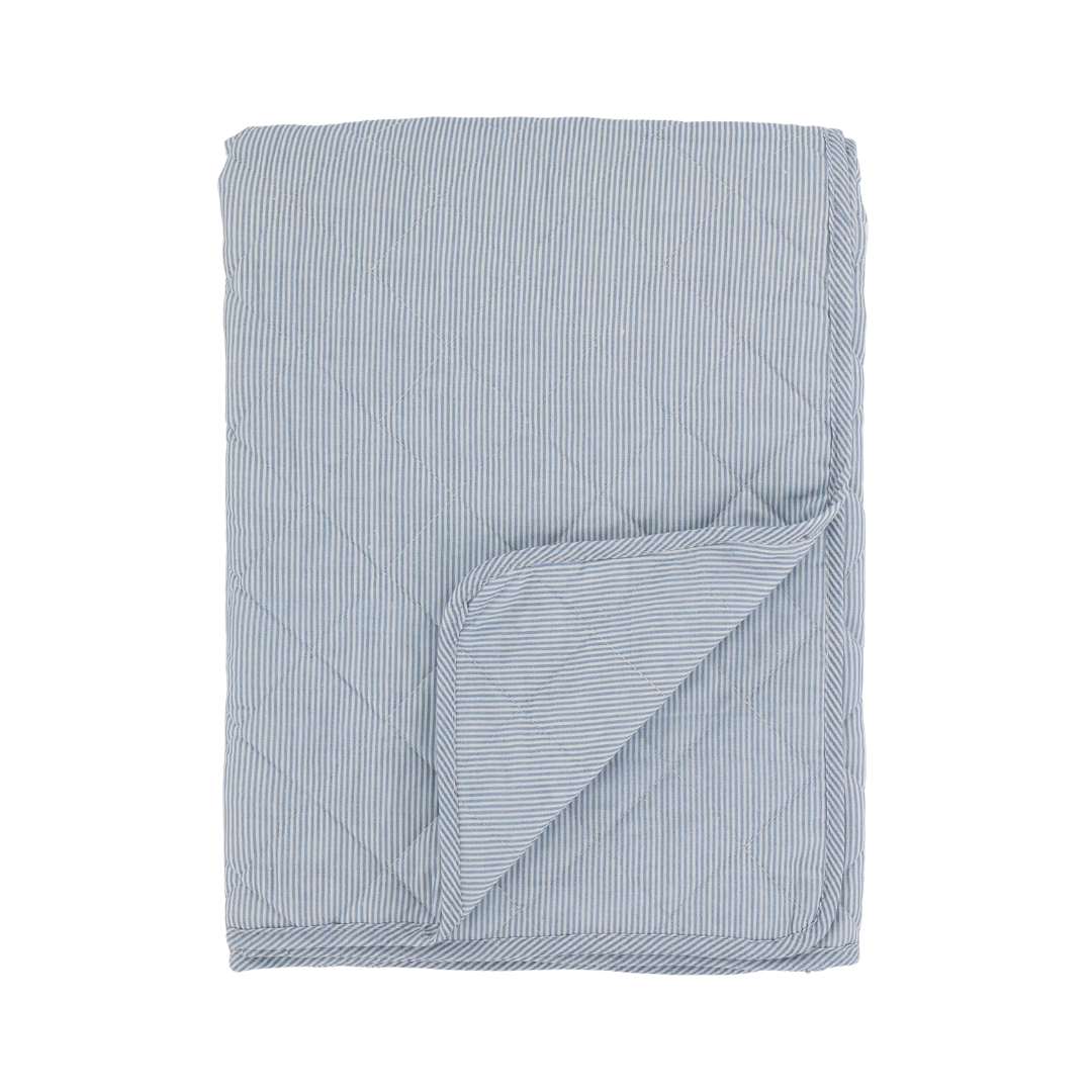 Blue and white striped quilt on a white background