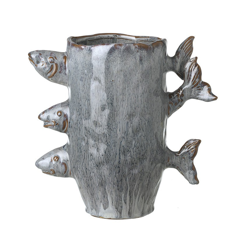 Ceramic blue glaze vase with fish sticking out of it on a white background