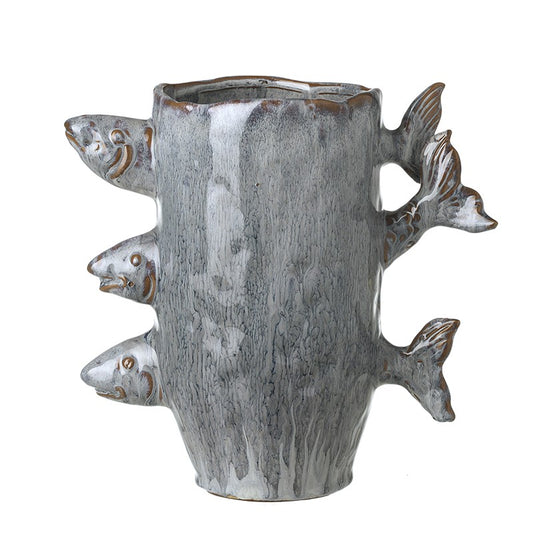 Ceramic blue glaze vase with fish sticking out of it on a white background