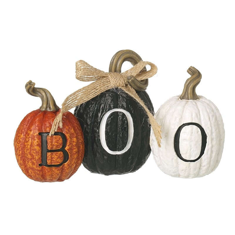 Decorative pumpkins spelling 'BOO' with a bow on a white background