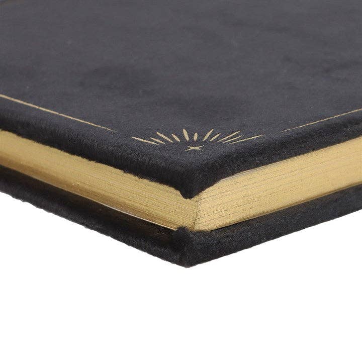 Black book with gold edges and a decorative design on a white background