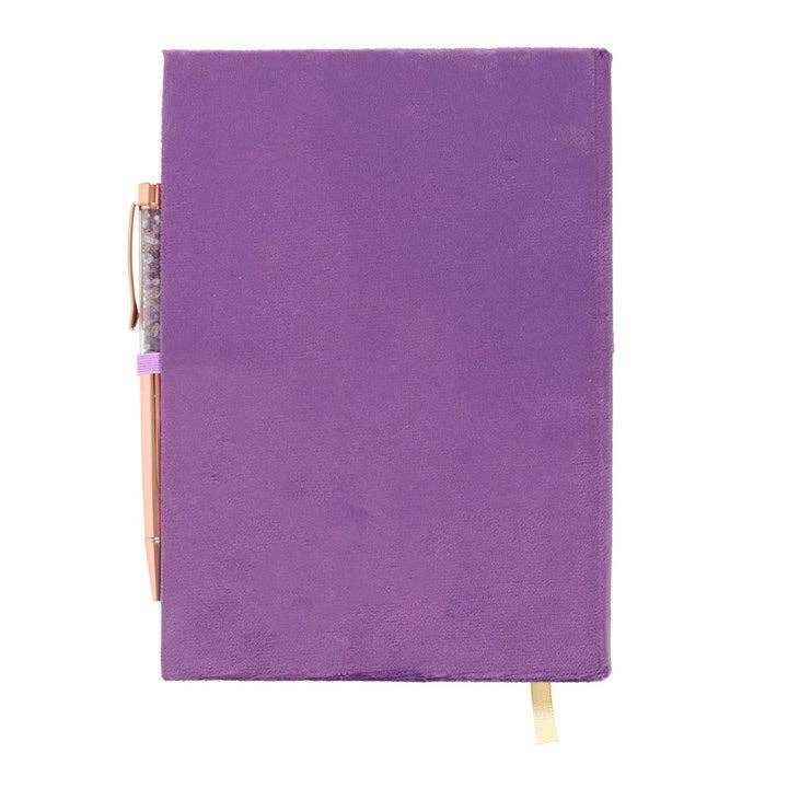 Purple notebook with a gold clip on a white background