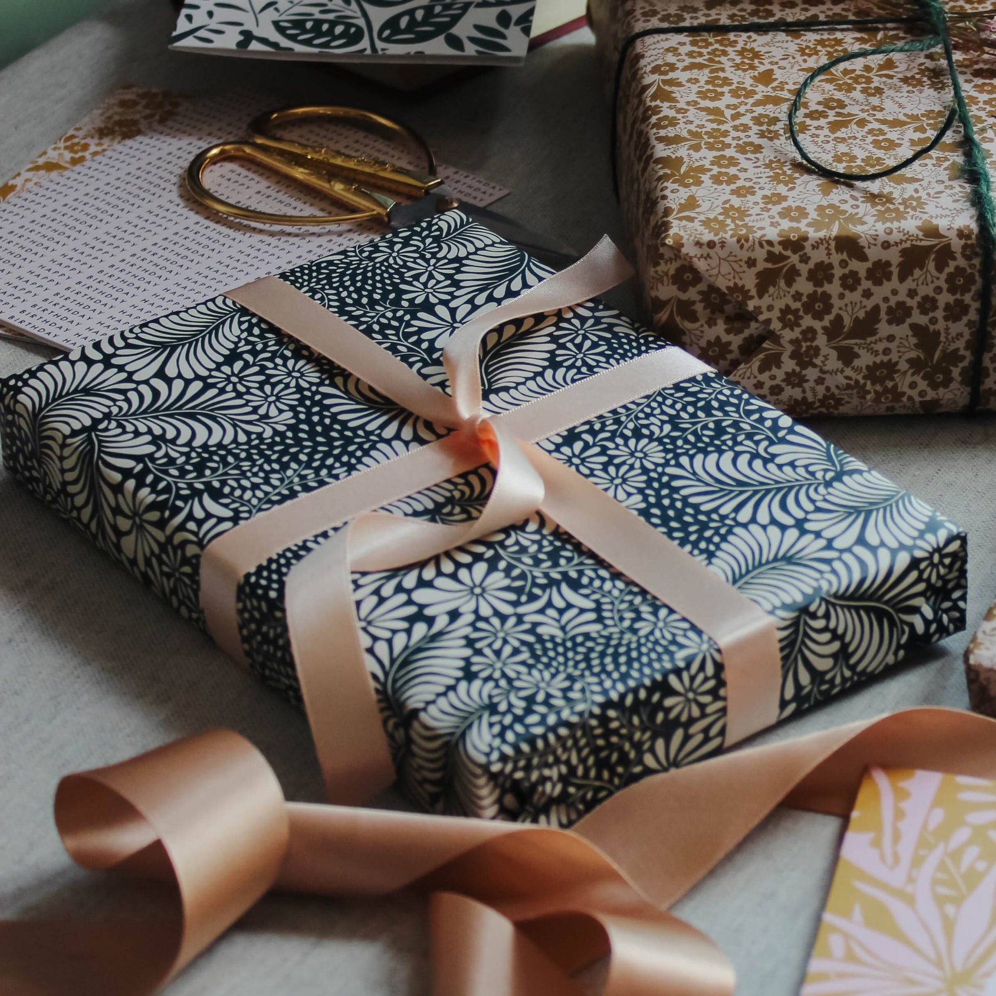  gift wrapped parcel on a table with a ribbon