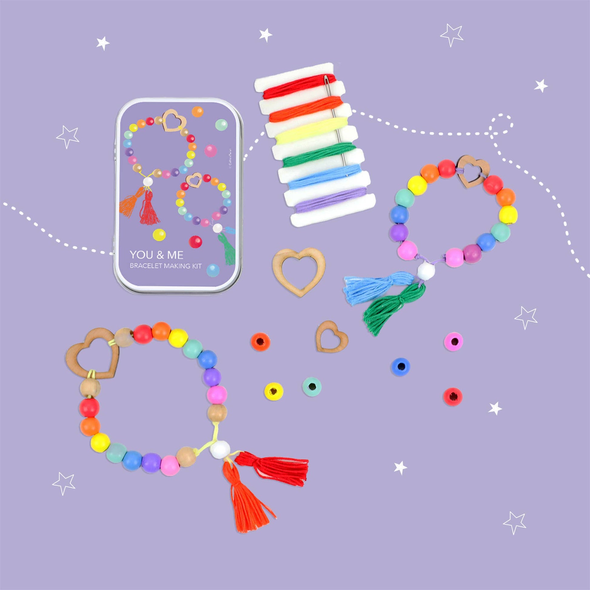 Colorful beaded bracelets with heart and tassel decorations on a purple background