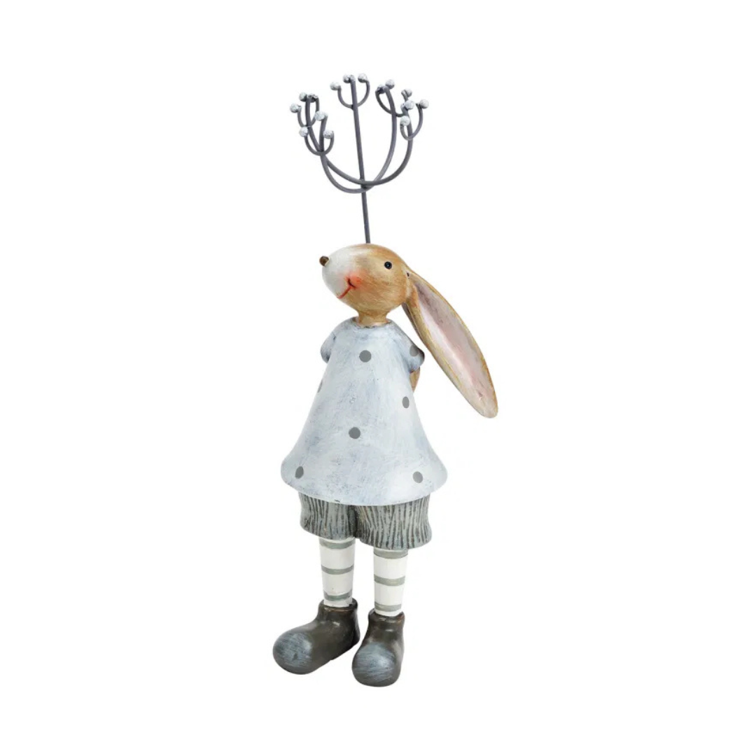 Decorative rabbit figure wearing a dress and boots on a white background