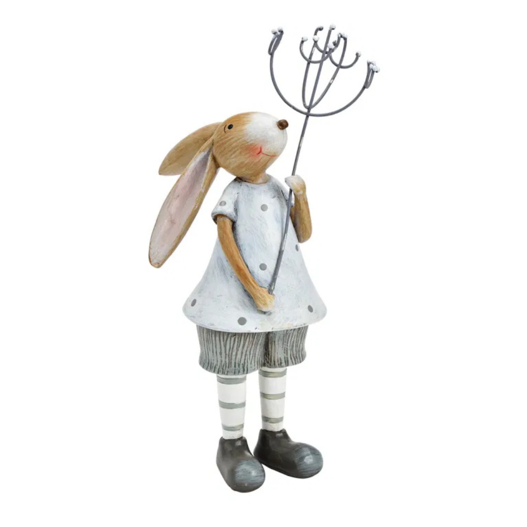 Decorative rabbit figure holding a whisk on a white background