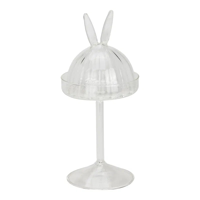 Clear glass stand with rabbit ears on a white background