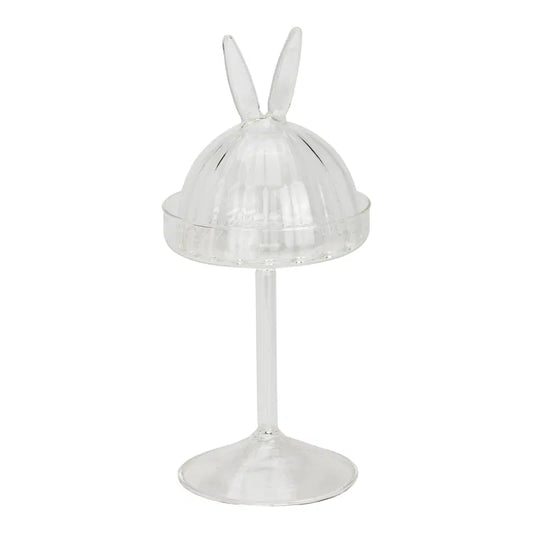 Clear glass stand with rabbit ears on a white background