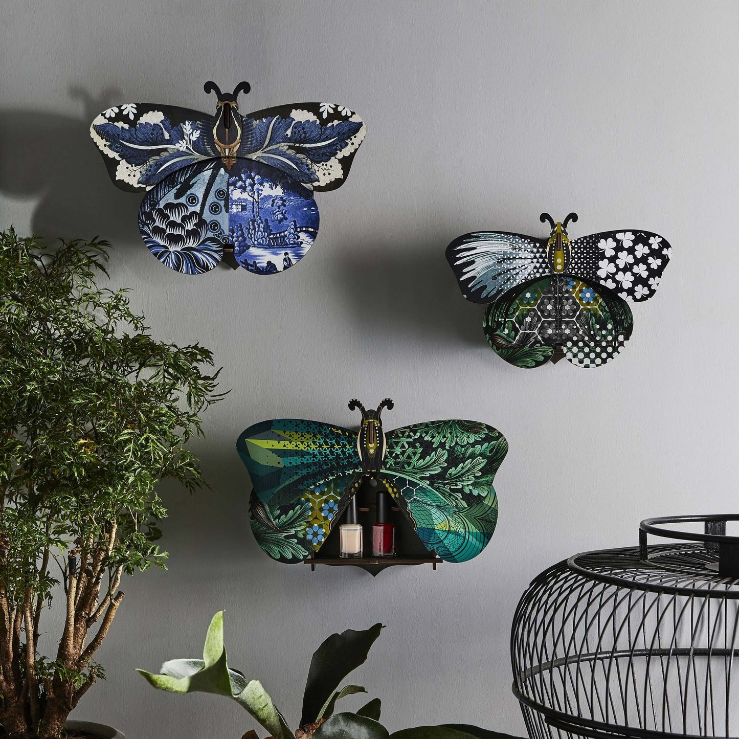 A decorative butterfly wall piece with hidden storage compartment, featuring a mix of floral and geometric patterns in a multicolored design.