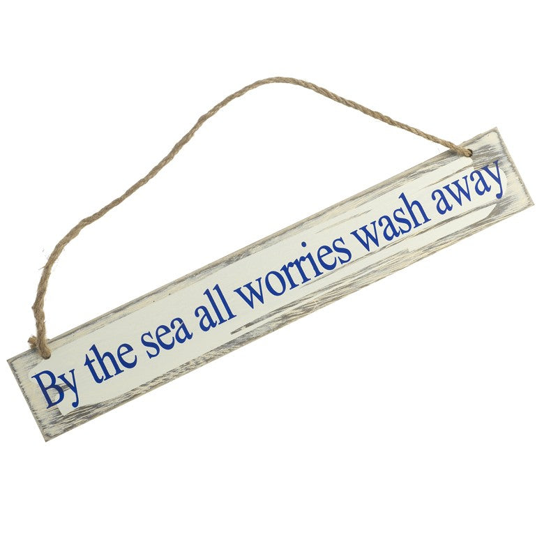 Wooden sign with 'By the sea all worries wash away' text on a white background