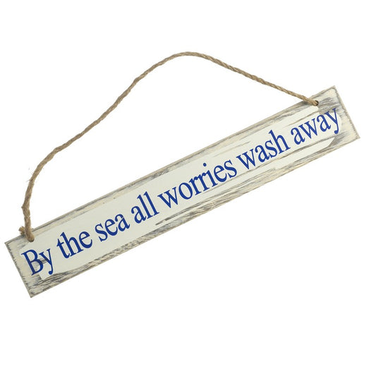 Wooden sign with 'By the sea all worries wash away' text on a white background