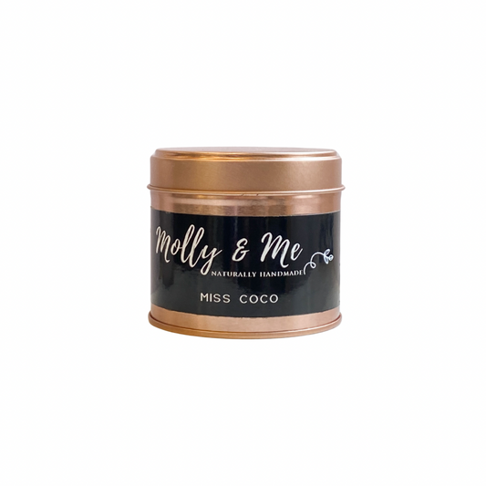 Candle tin with 'molly & me' branding on a white background