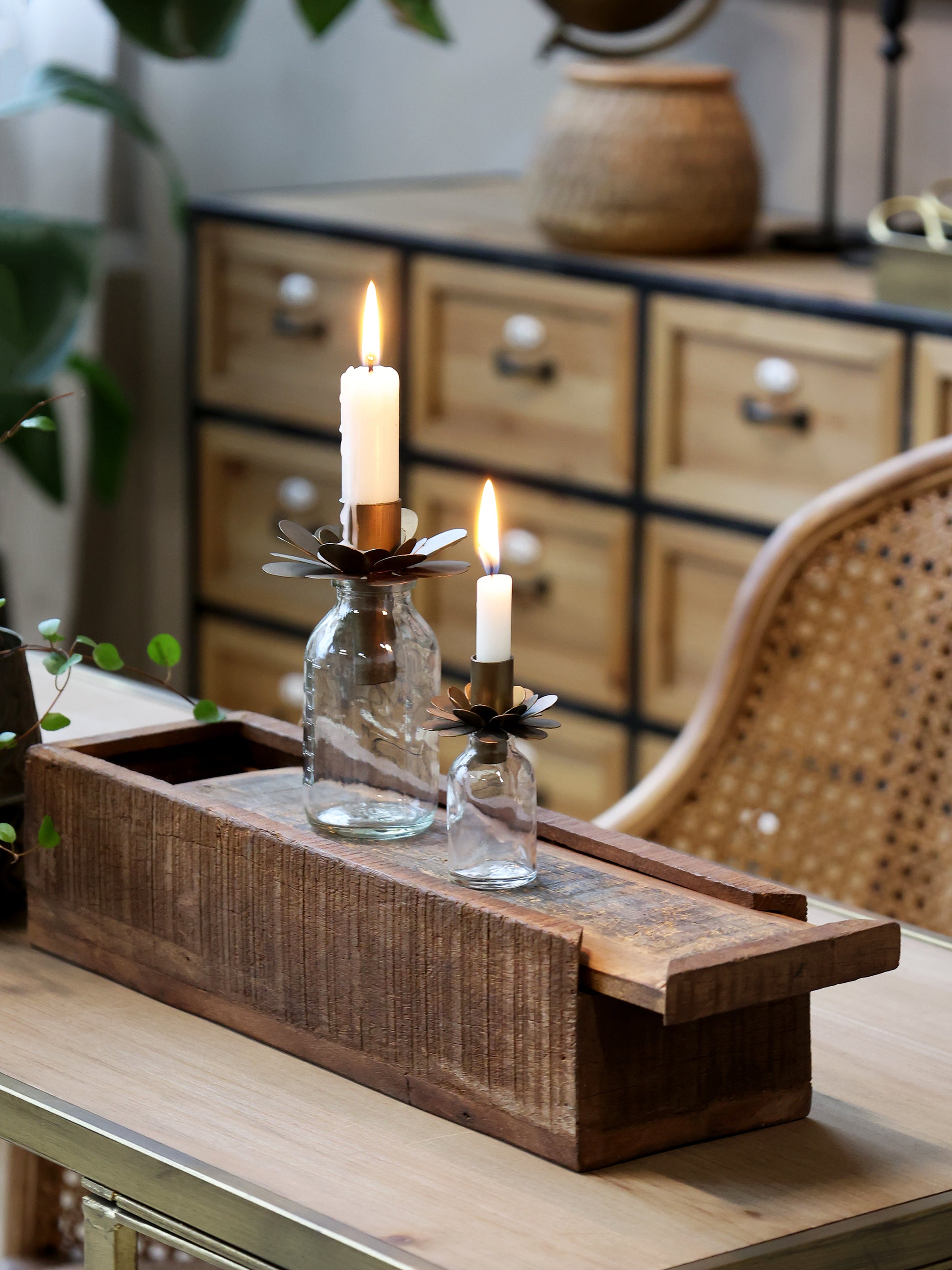 Wooden tray with candles on a table in a home setting