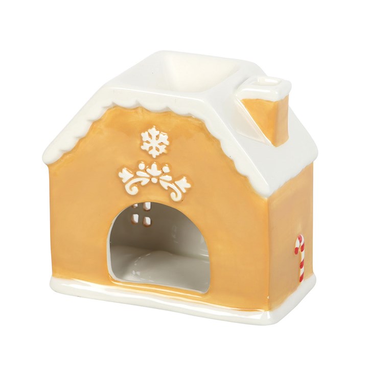 Decorative gingerbread house-shaped oil burner on a white background