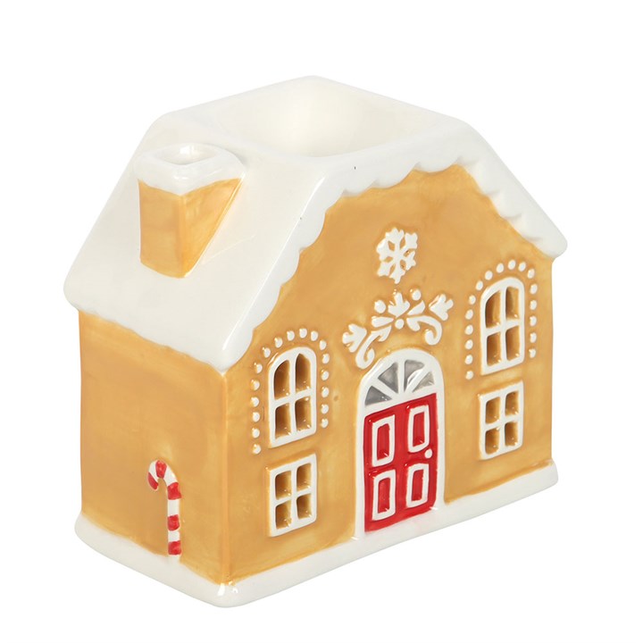 Decorative gingerbread house wax warmer with a red door on a white background