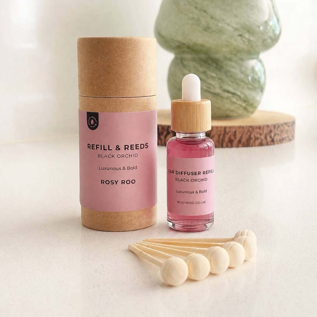 Refill and Reed diffuser set with pink liquid and wooden sticks on a light surface.