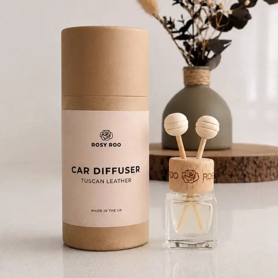 Cardboard branded tube packaging beside a car diffuser. Tuscan leather