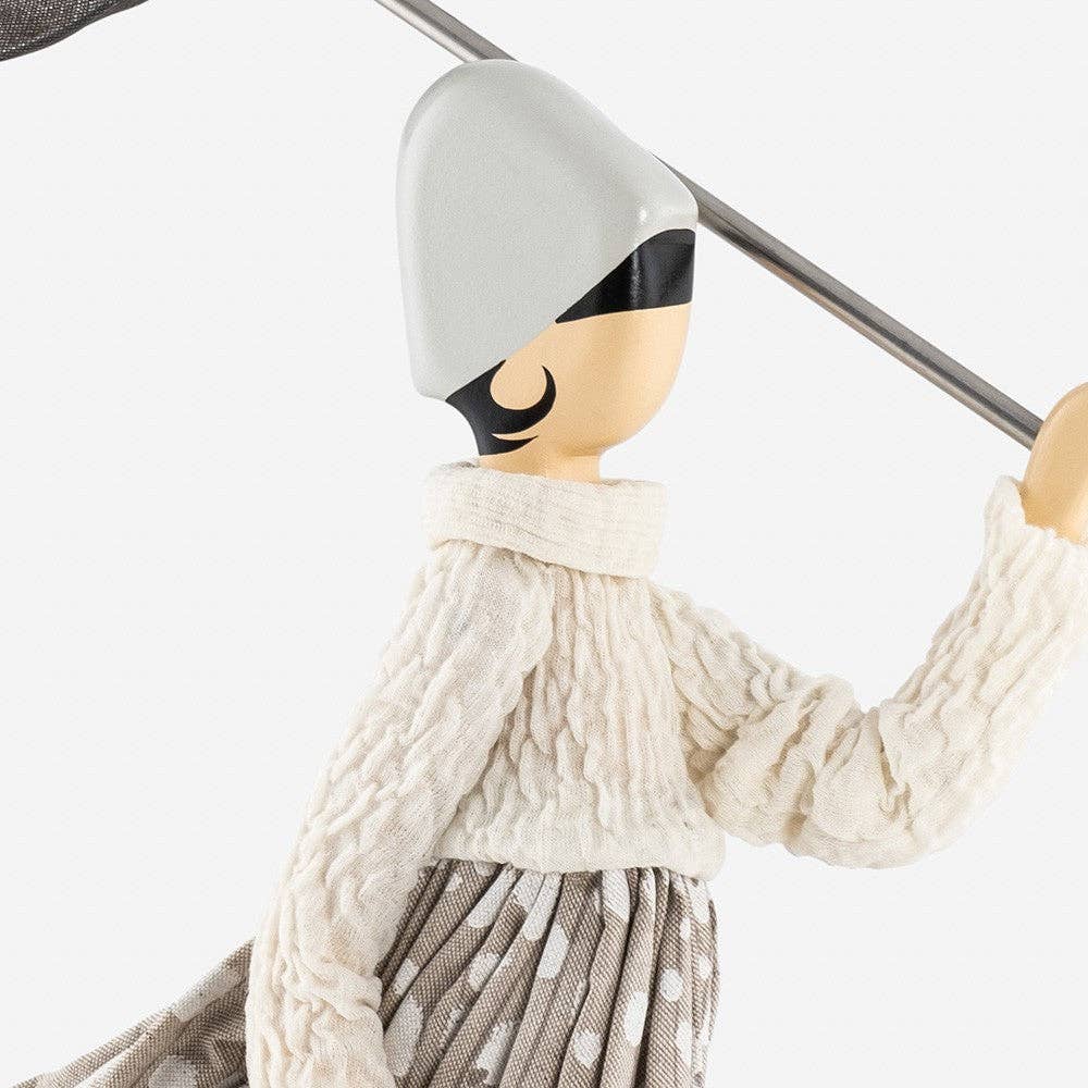Close-up of a lady lamp with a white hat and beige outfit on a white background