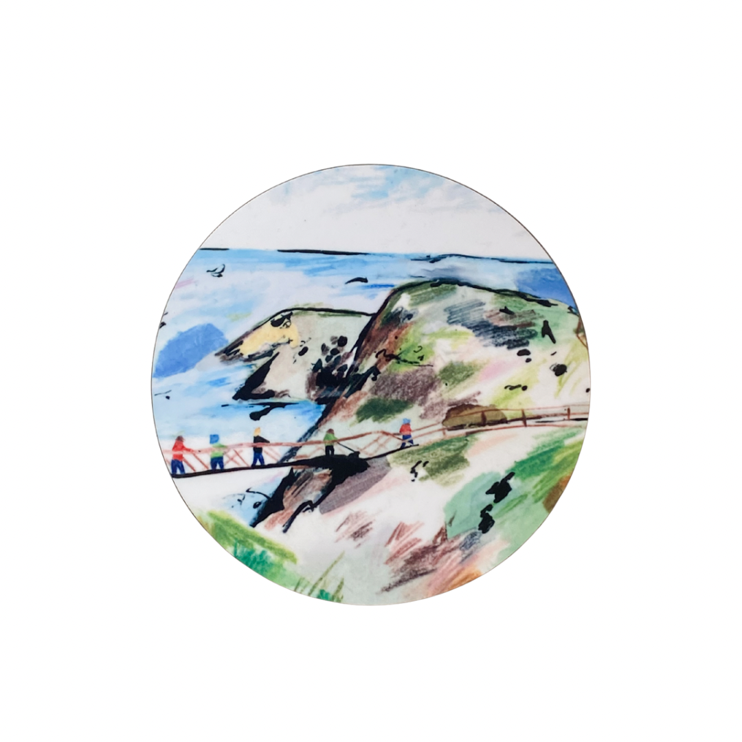 Round coaster with a scenic design of people on a bridge over water.
