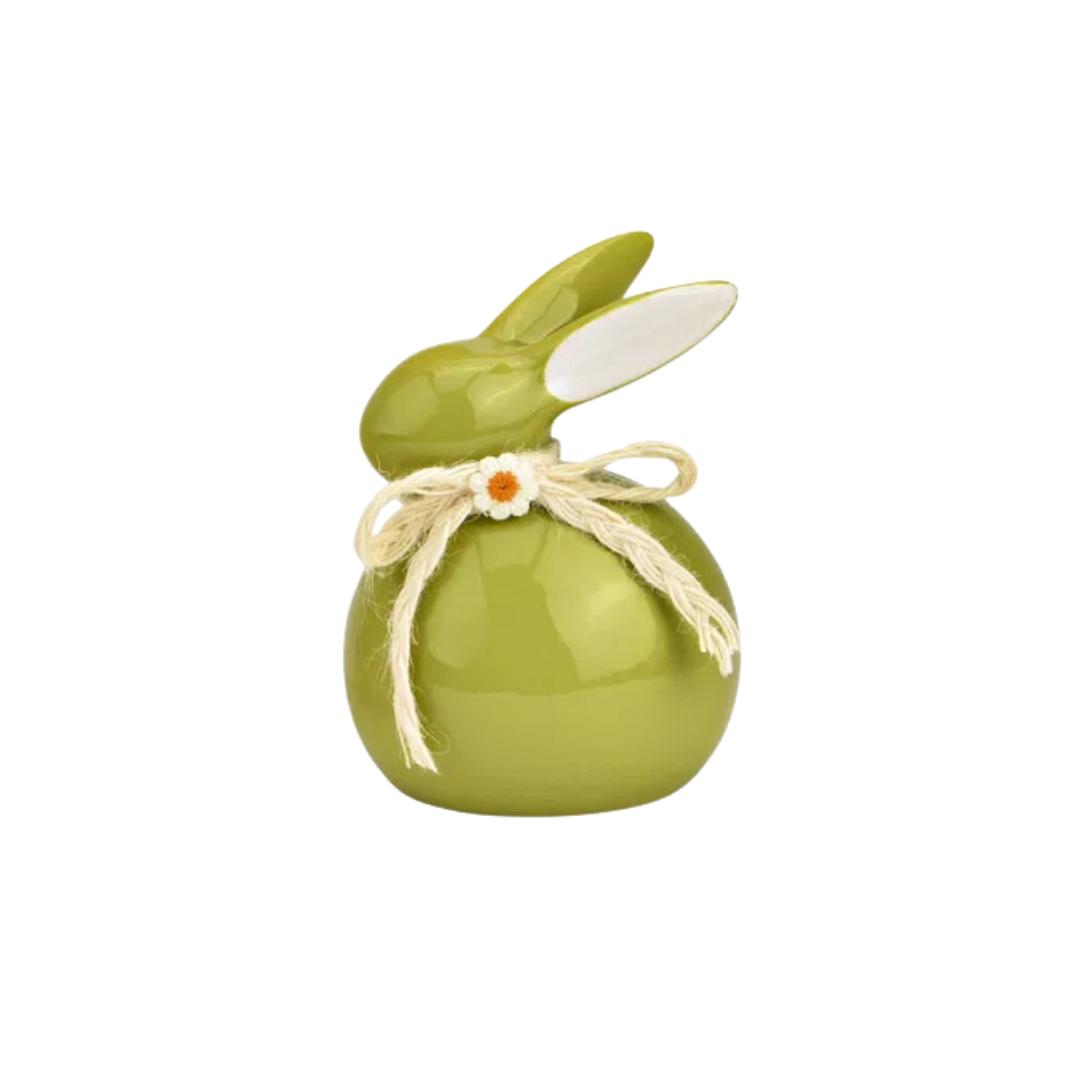 Green ceramic bunny with a bow on a white background