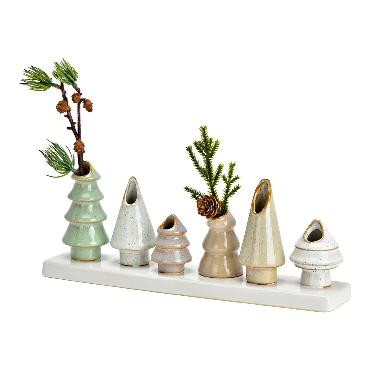 Set of ceramic Christmas trees with greenery and pinecones on a white background