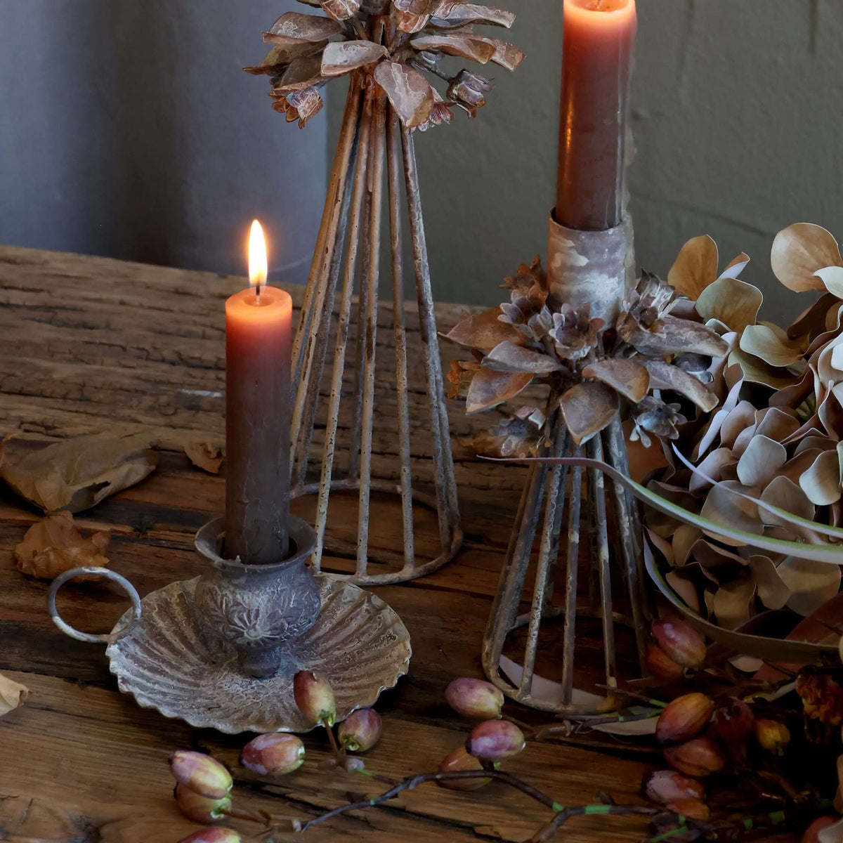 A collection of rustic candle holders on a table