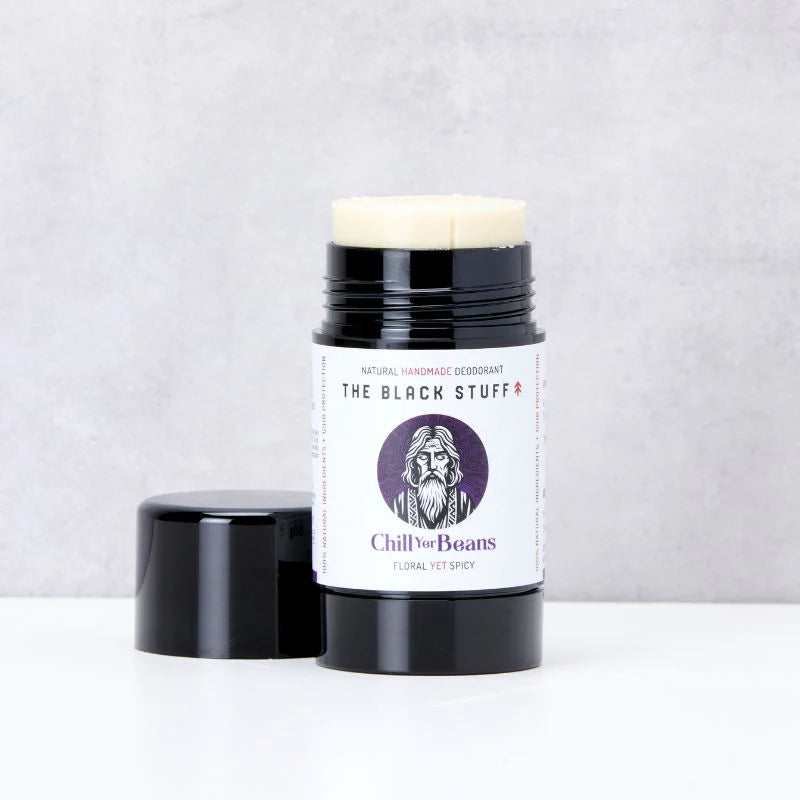 Deodorant stick with a label featuring a beard illustration on a light gray background