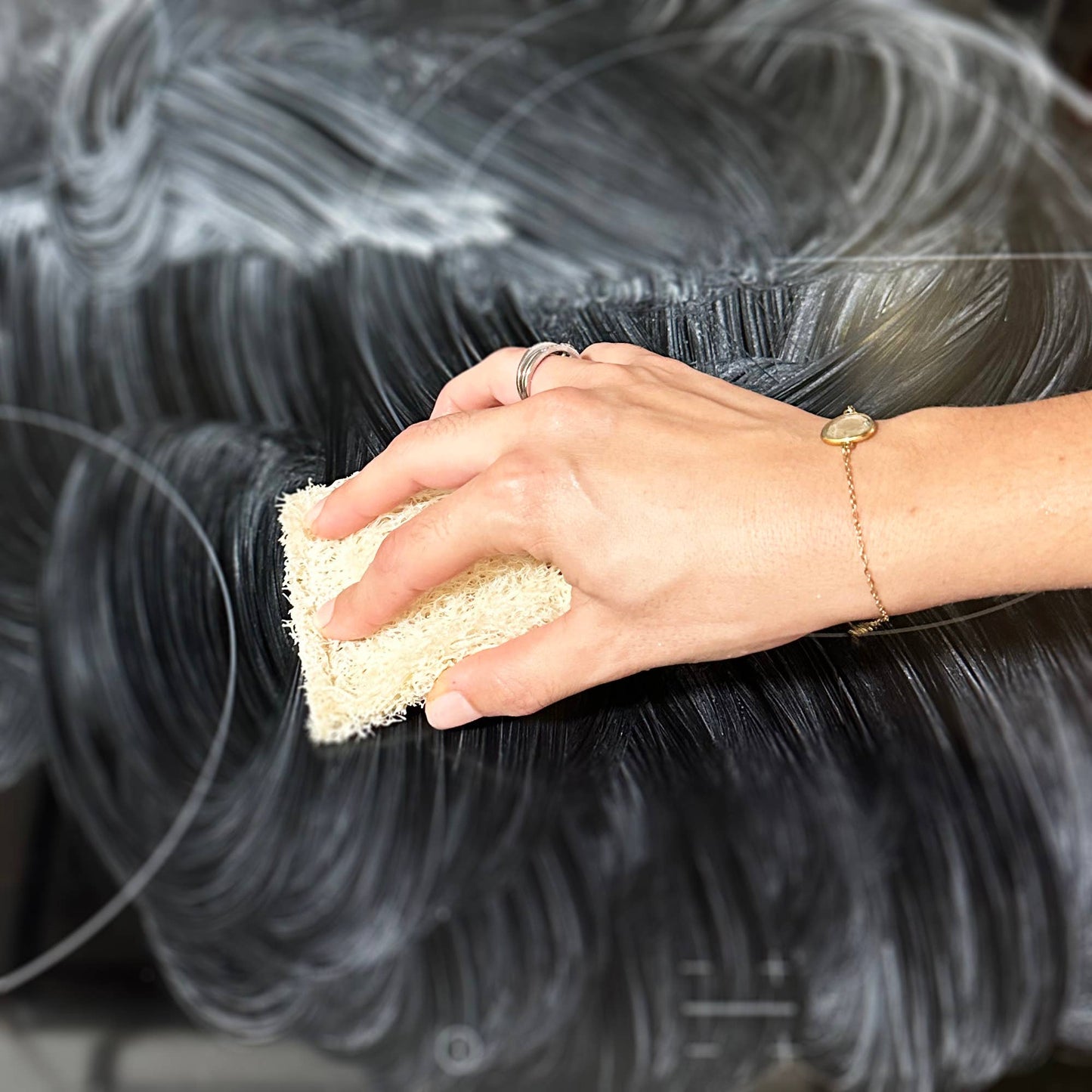 Hand used a cleaner on an oven door