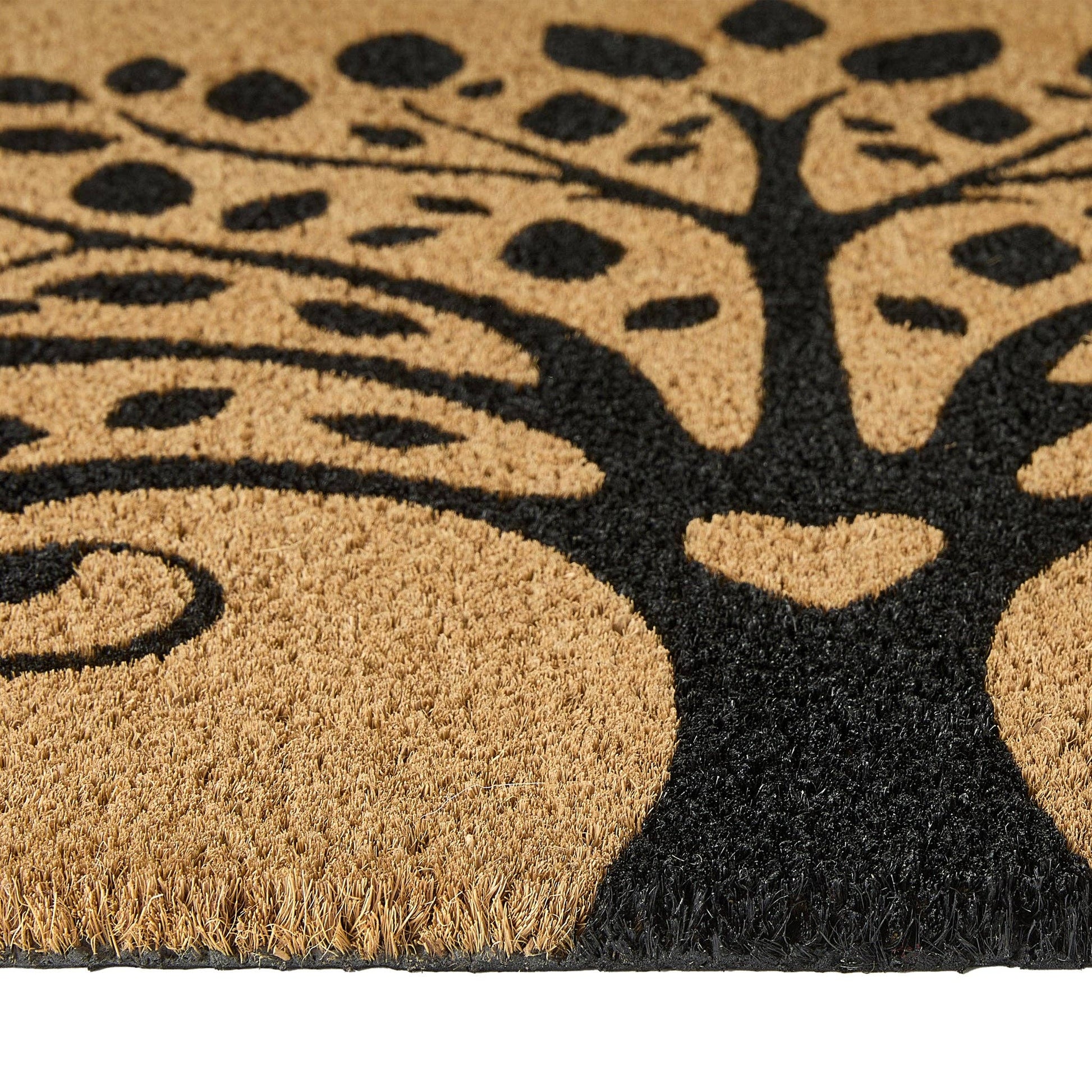 Doormat with a tree design featuring a heart at the base