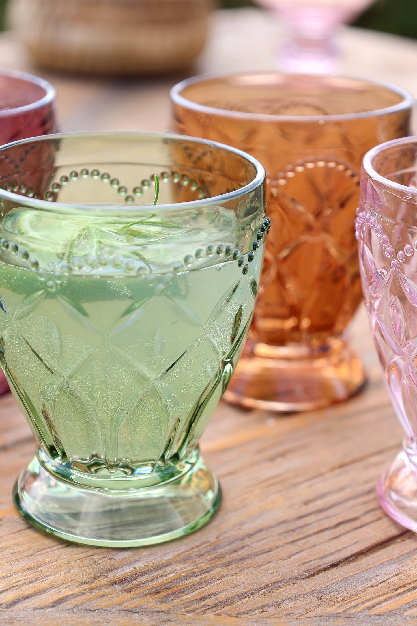 Colorful textured glass tumblers on a wooden surface
