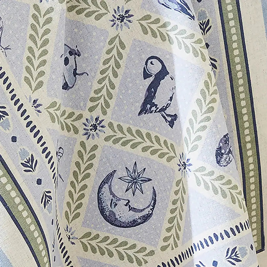 Fabric with nature-themed pattern featuring animals, plants, and celestial symbols.