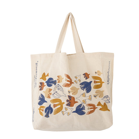 Beige tote bag with colorful bird pattern on a white background