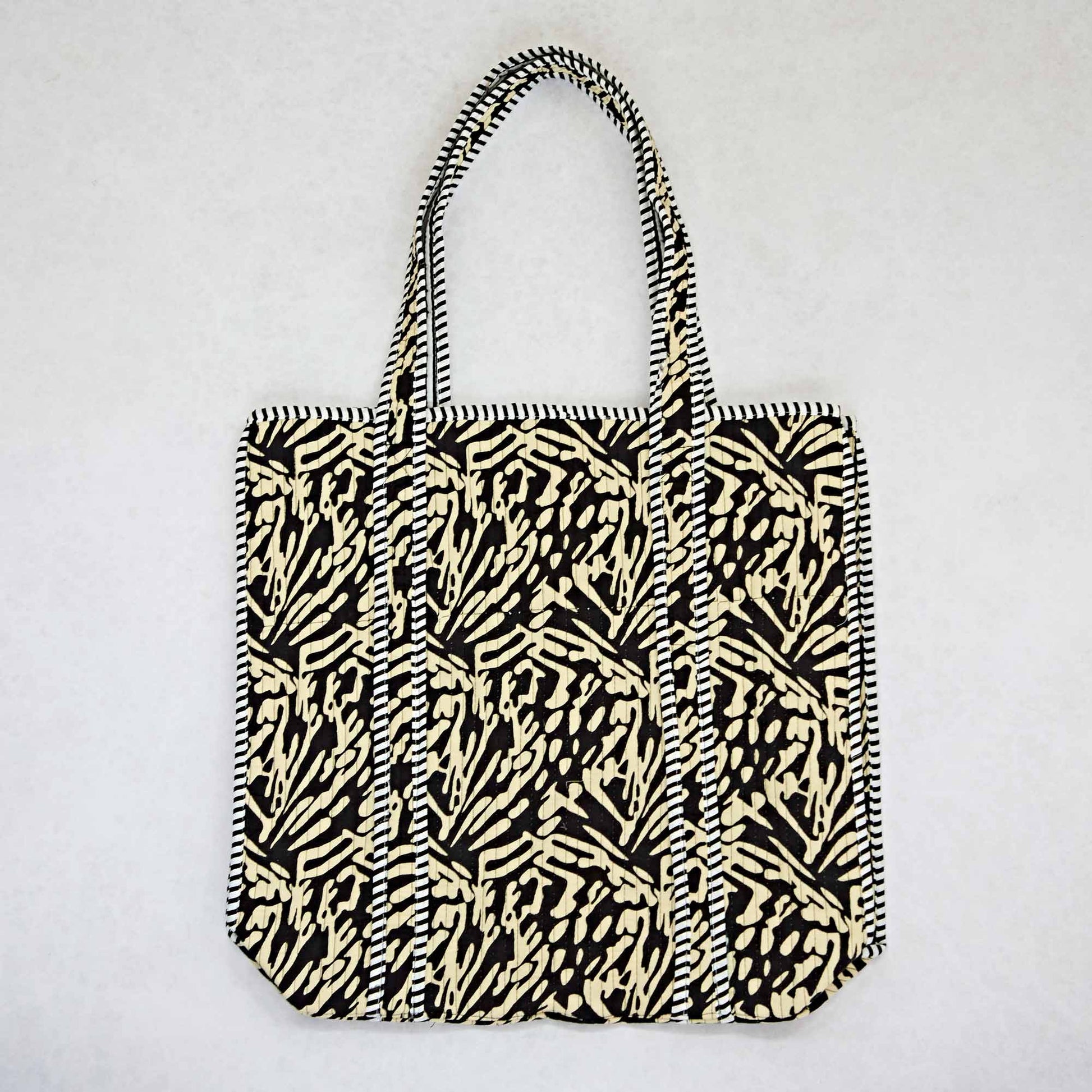 Tote bag with black and white pattern on a light gray background