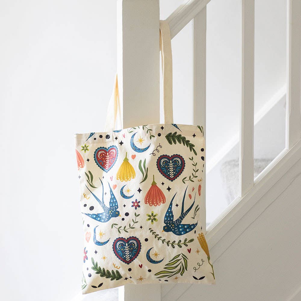 Tote bag with colorful patterns hanging on a white door frame
