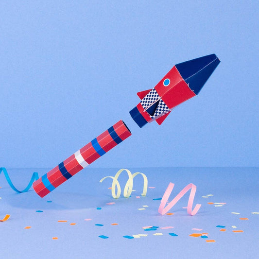 Colorful toy rocket with checkered pattern on a blue background