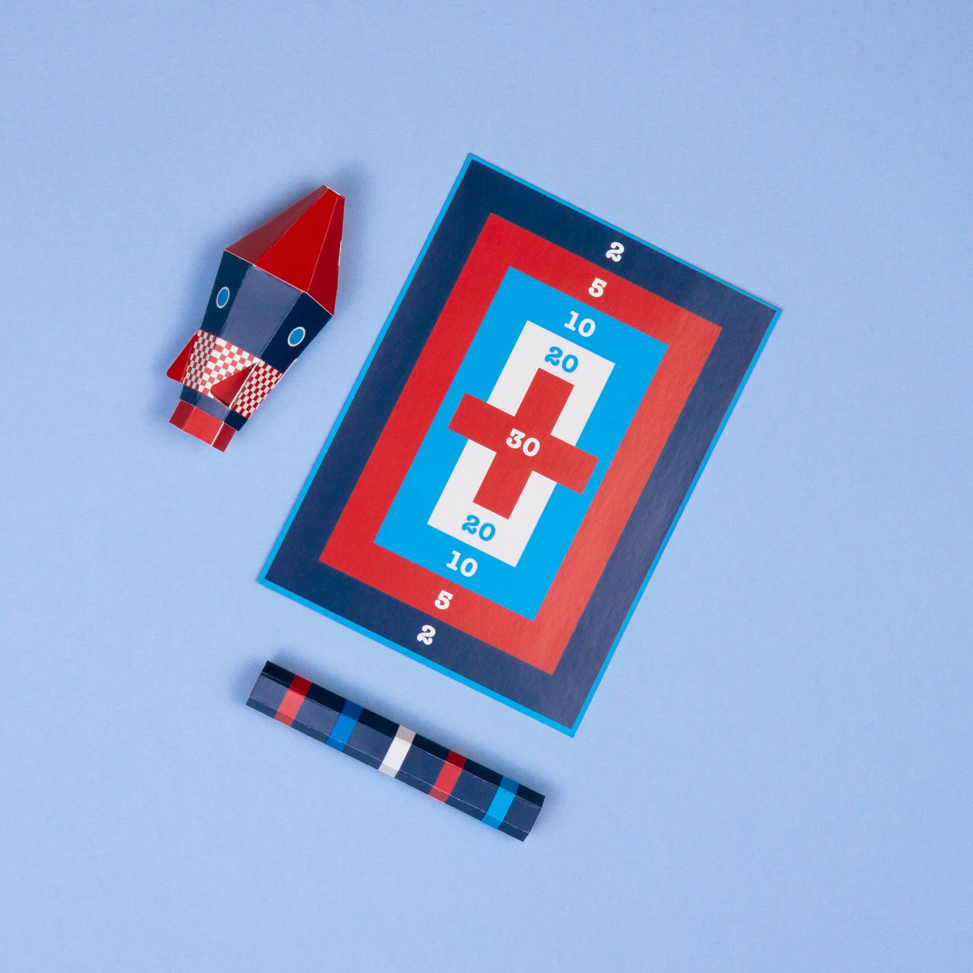 Toy rocket and target on a blue background
