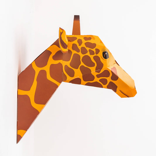 Giraffe-shaped paper cutout on a white background