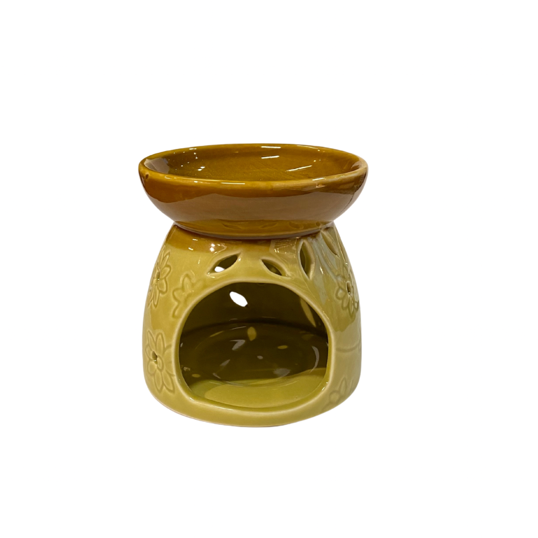 Yellow ceramic oil burner with decorative design on a white background